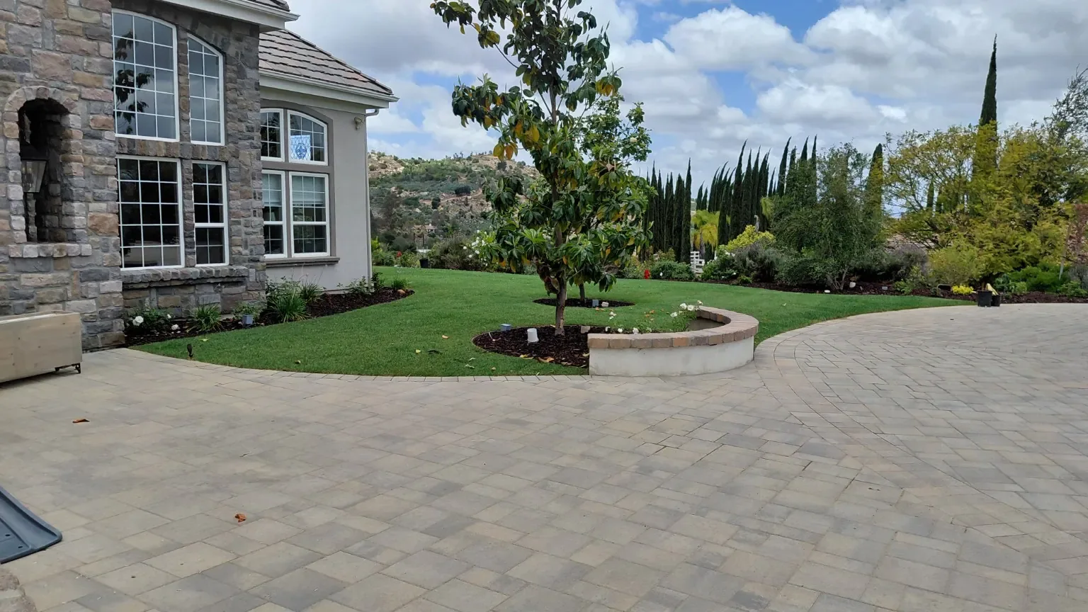 After: Finished lawn around the existing courtyard and circular planter.