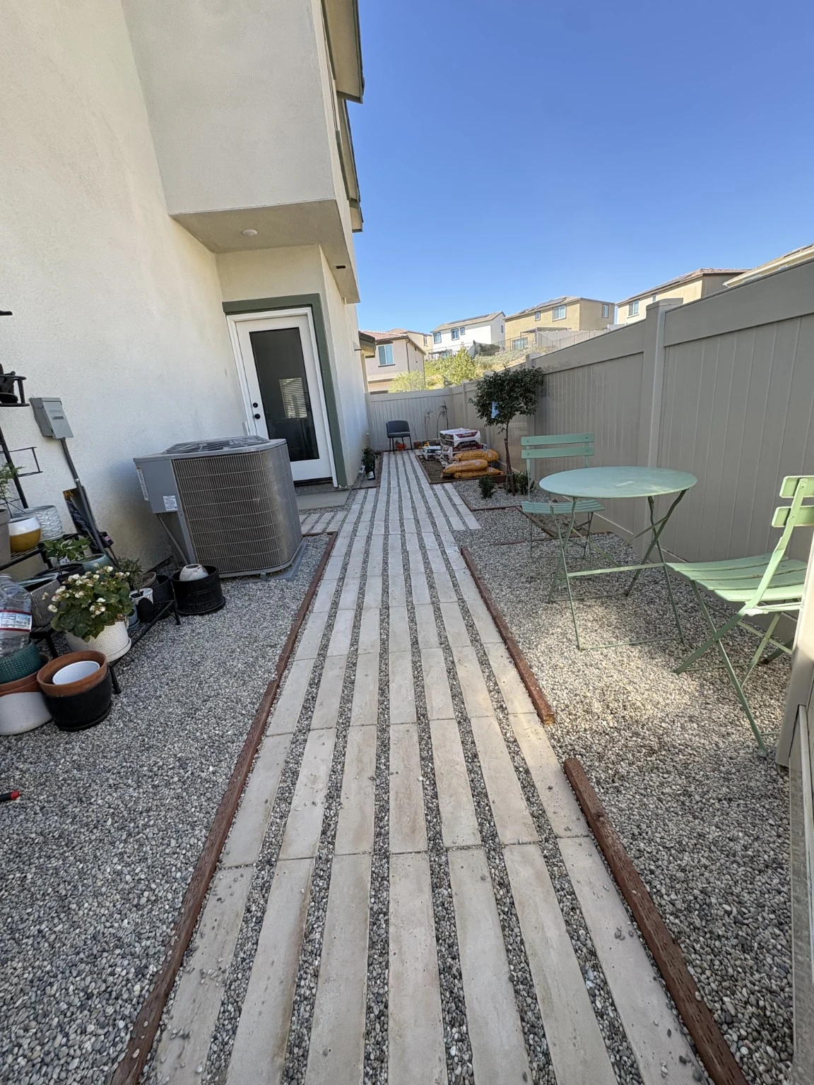 After: Completed paver and gravel walkway viewed toward the side door.