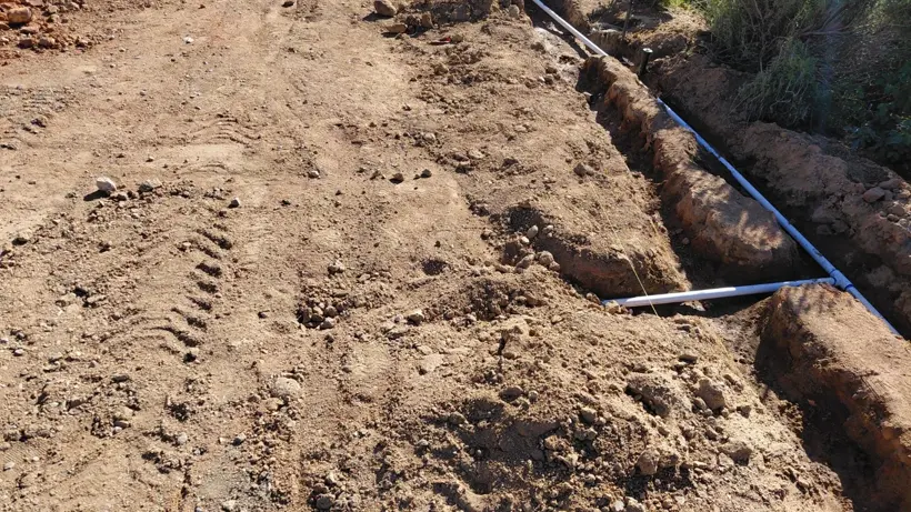 Utility trenches opened across the future landscape area.