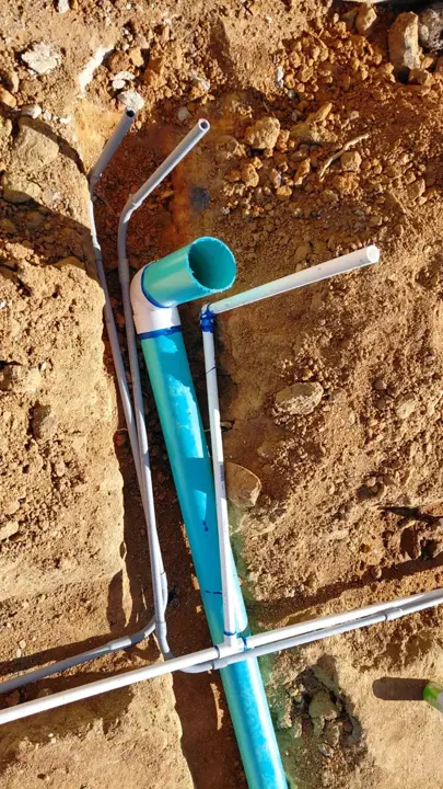 Vertical pipe connections at a drain-line junction.