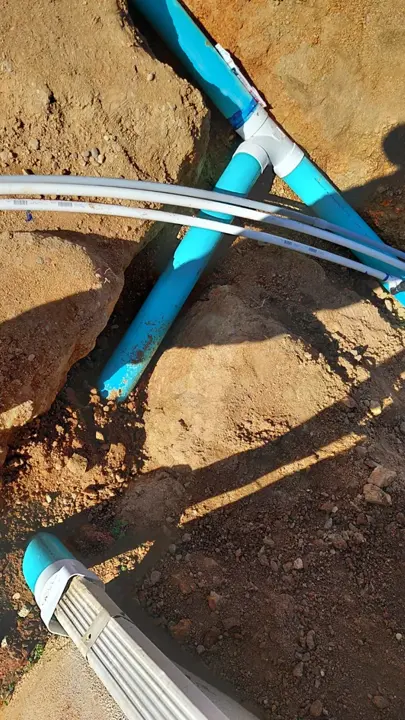 A close view of connected lines in an open trench.