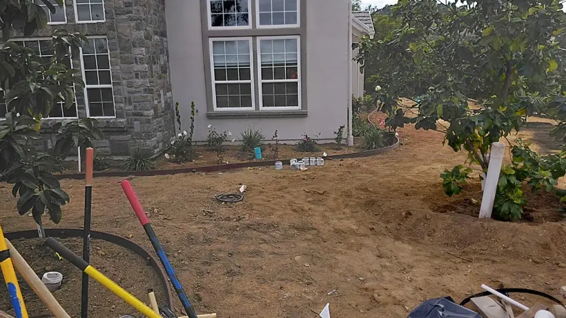 Leveling the lawn area and defining the planting edges.