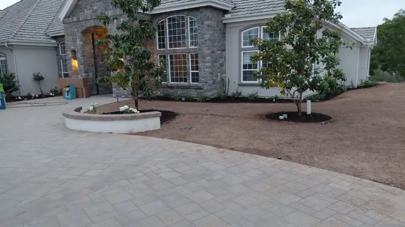 The prepared lawn area beside the paver courtyard.