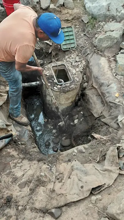 Work on the collection basin at the base of a rock water feature.