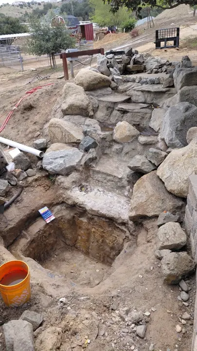 Placing boulders and shaping the rock cascade.
