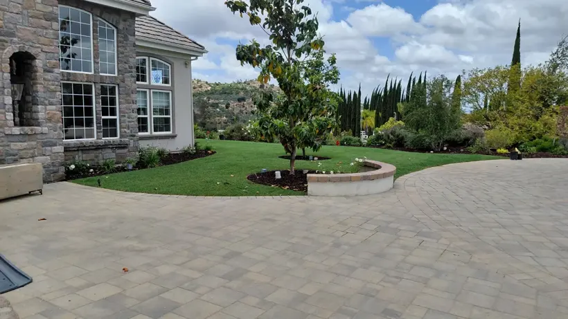 Finished lawn around the existing courtyard and circular planter.