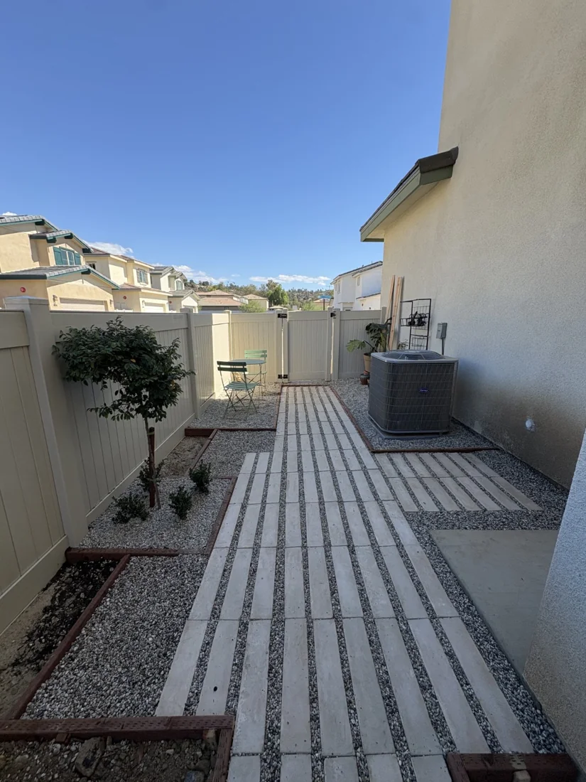 Completed paver and gravel walkway viewed toward the side gate.