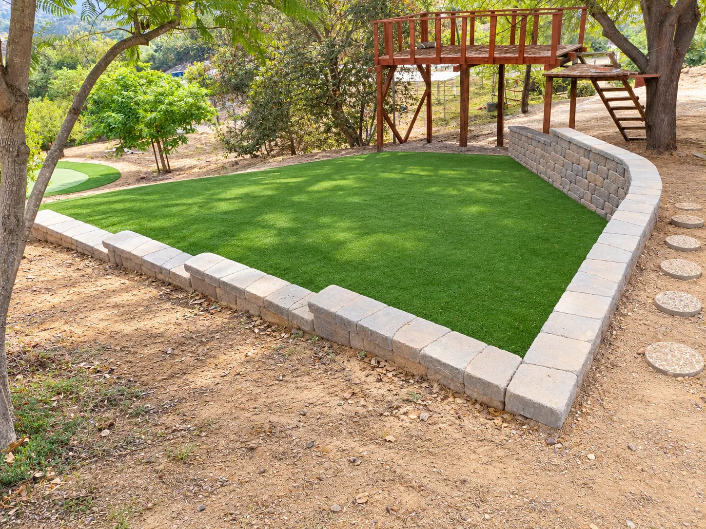 After: Finished artificial turf with the matching low block border. Photo retouched to remove temporary items, improve lighting, and crop foreground dirt.